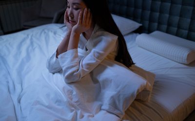 woman sitting in bed with insomnia
